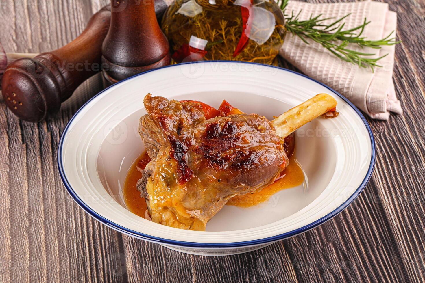 Baked lamb shank with vegetables photo
