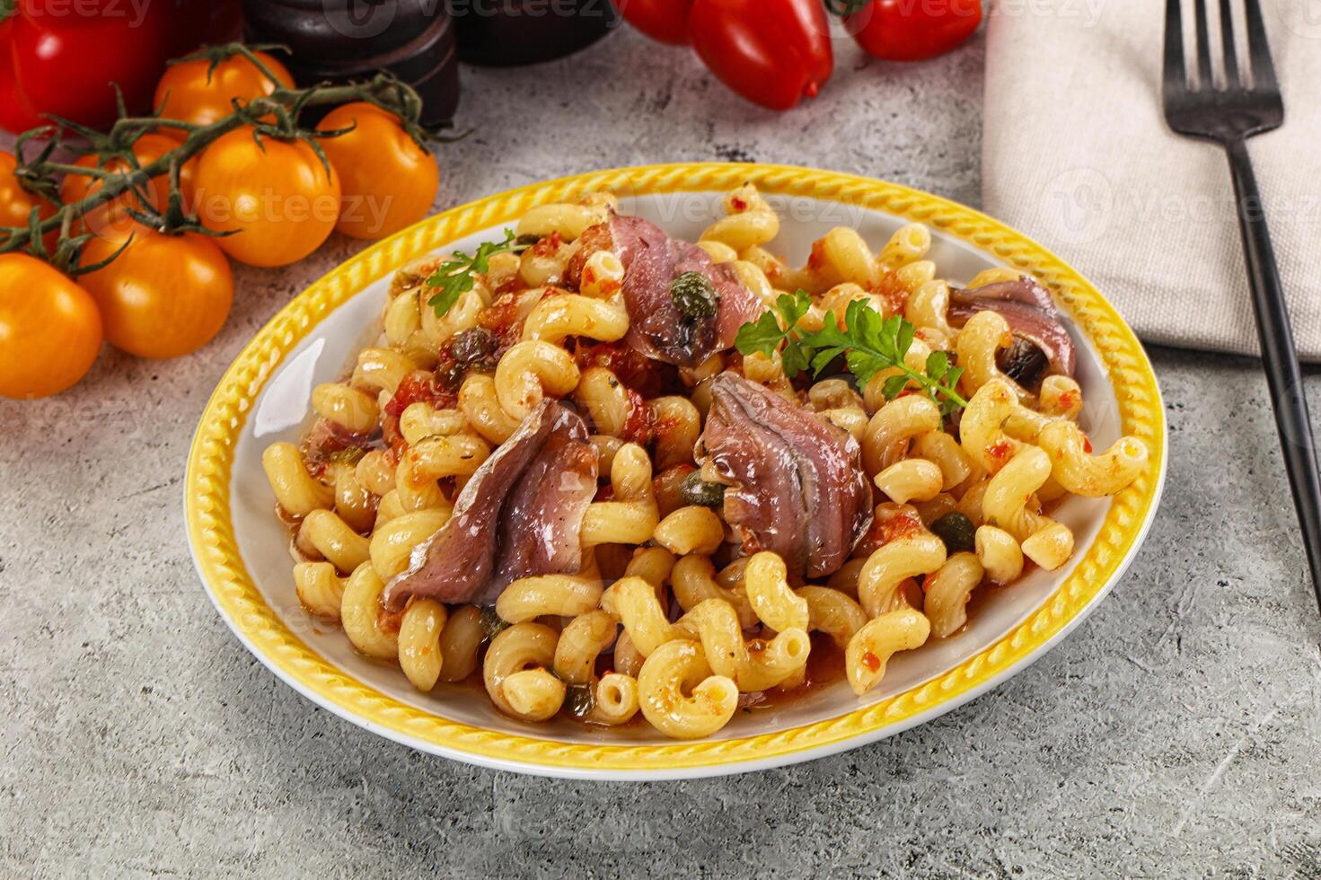 Italian pasta cellentani with anchovy photo