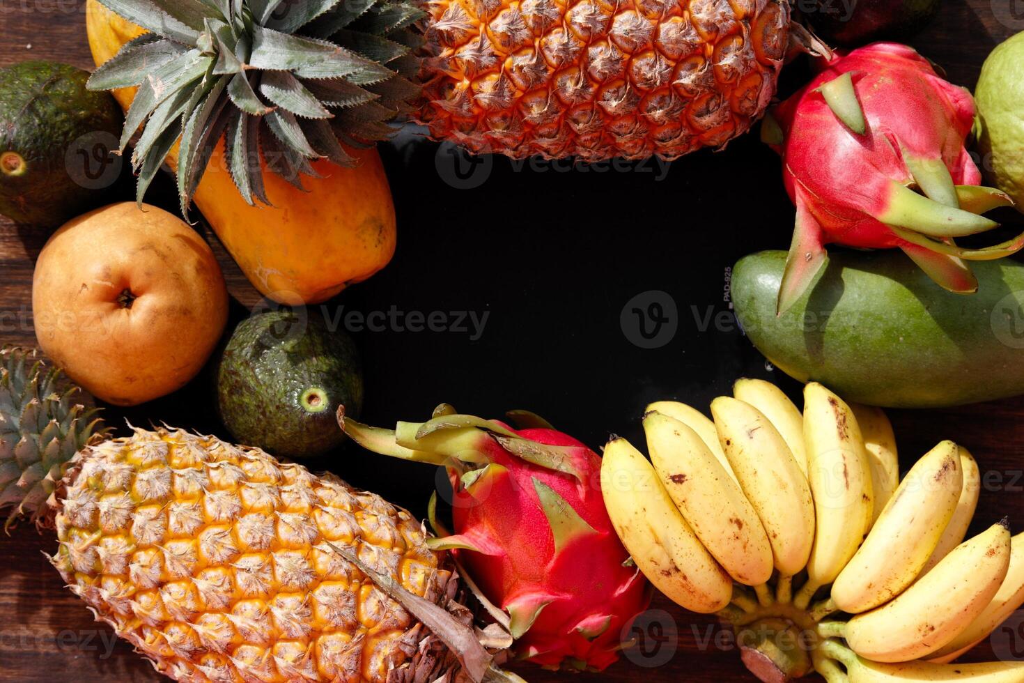 Fresh fruits and vegetables from Thailand and Bali beautifully arranged on a wooden table photo