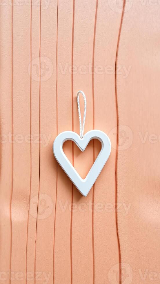 White Heart Ornament on Peach Wooden Background photo