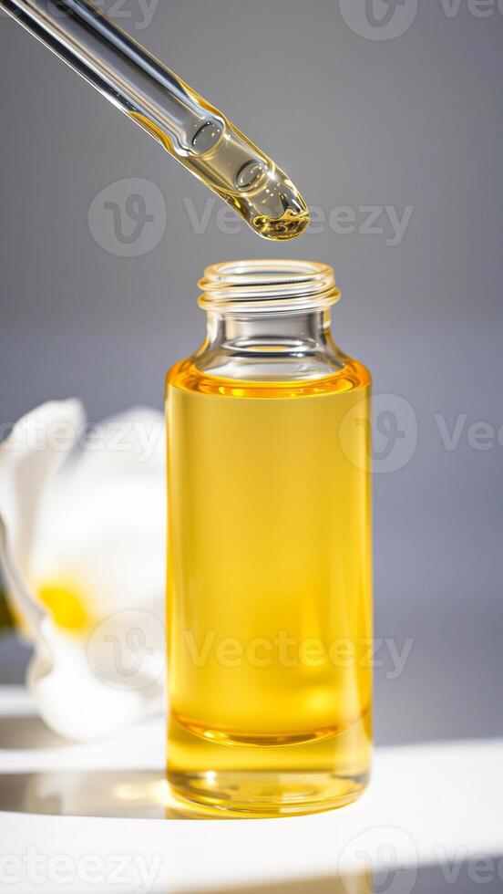 Dropper Bottle with Yellow Liquid and a Flower photo