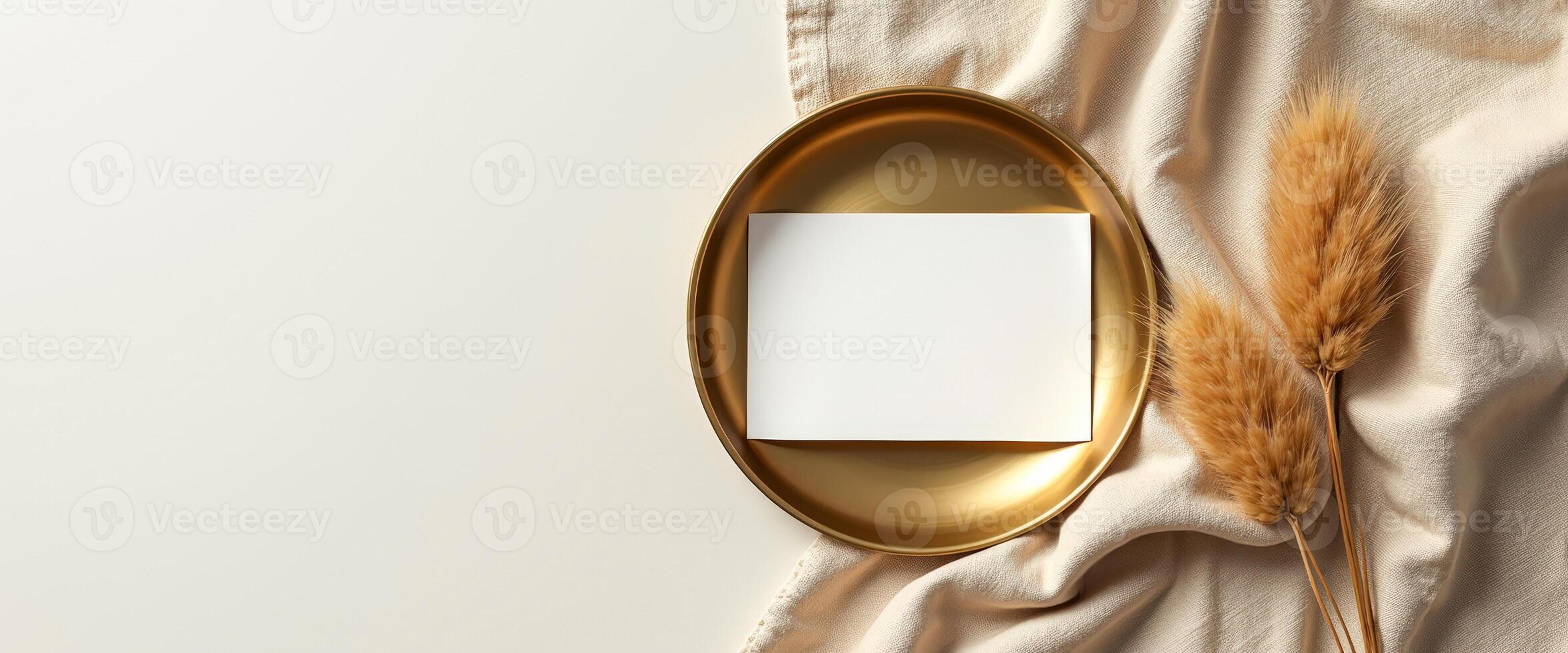 Blank Card on a Gold Plate with Dried Grass photo