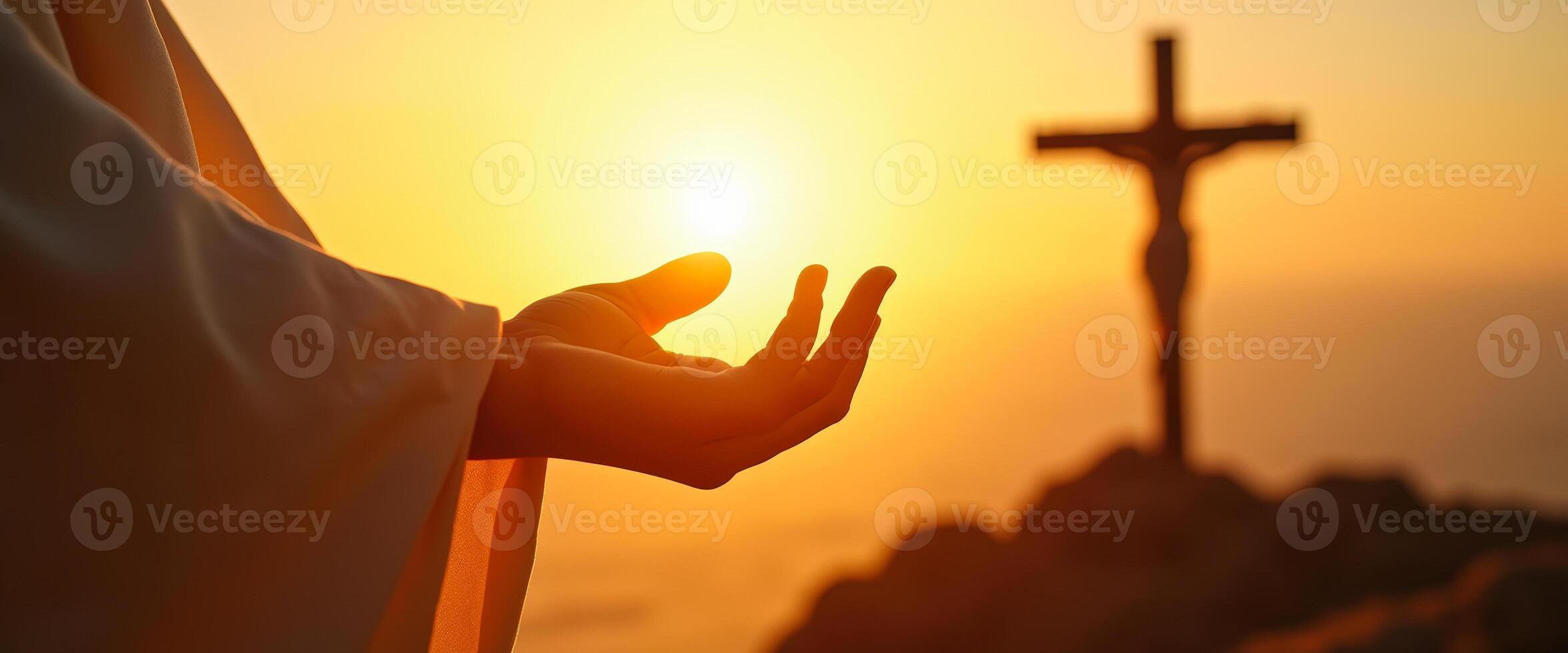 Hand reaching towards the sun with cross in the background photo