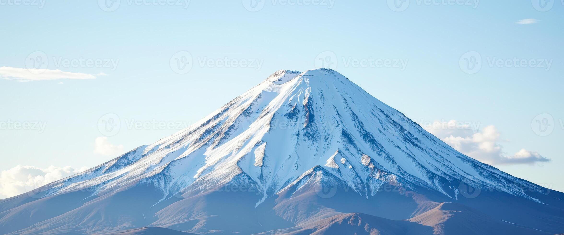 Majestic Snow-Capped Mountain Peak Against a Clear Blue Sky photo