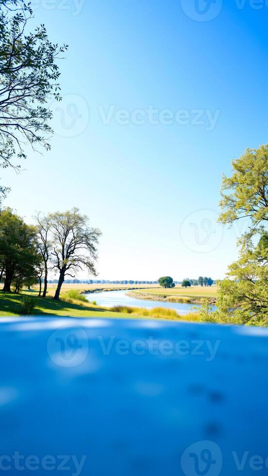 River Landscape with Blue Sky and Lush Greenery photo