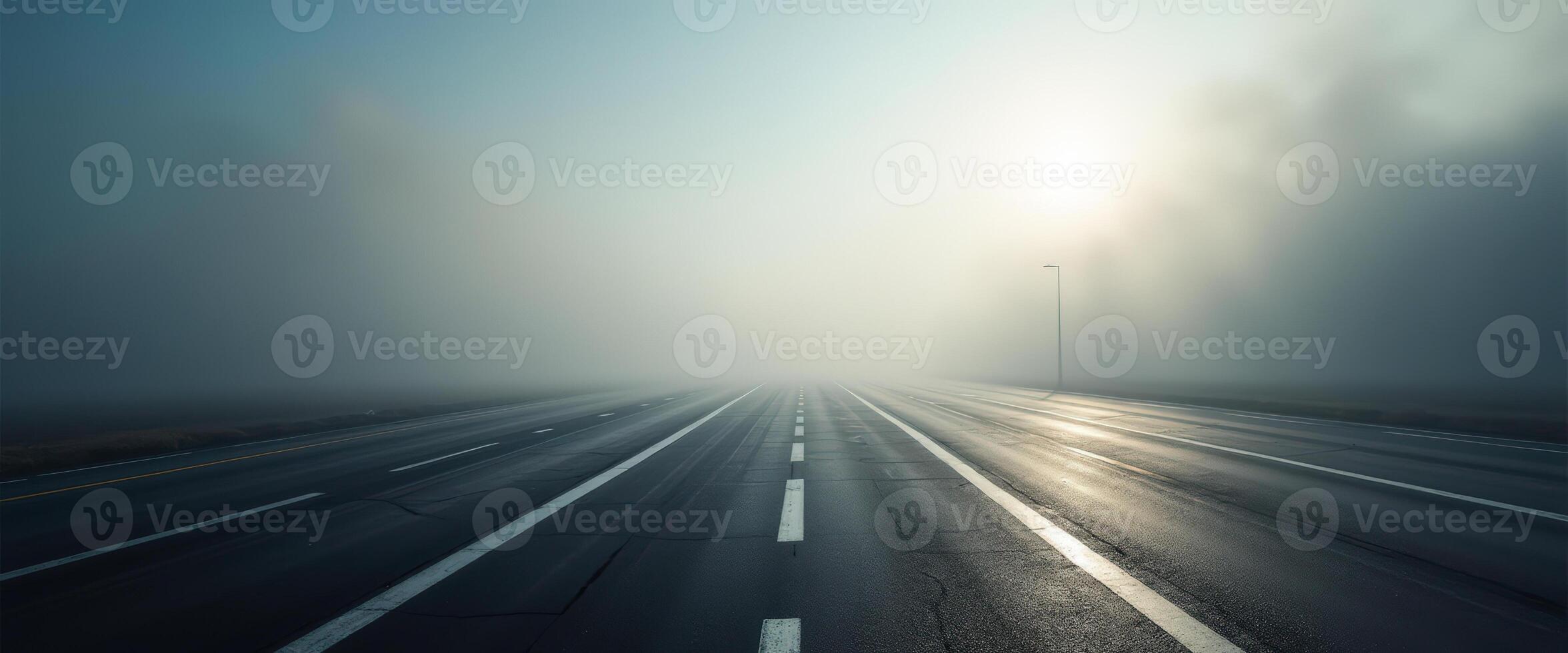 Empty Highway Disappearing Into Fog photo
