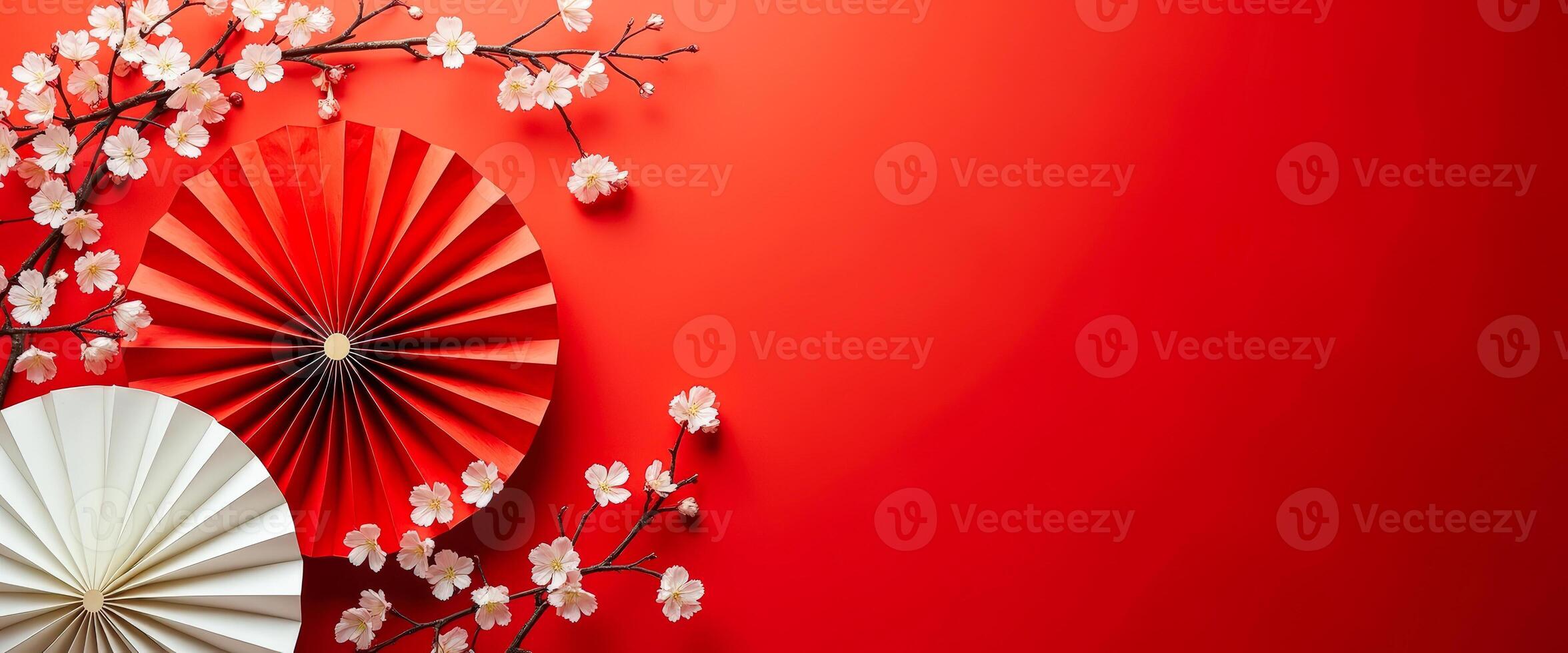 Red and White Paper Fans and Cherry Blossoms on Red Background photo