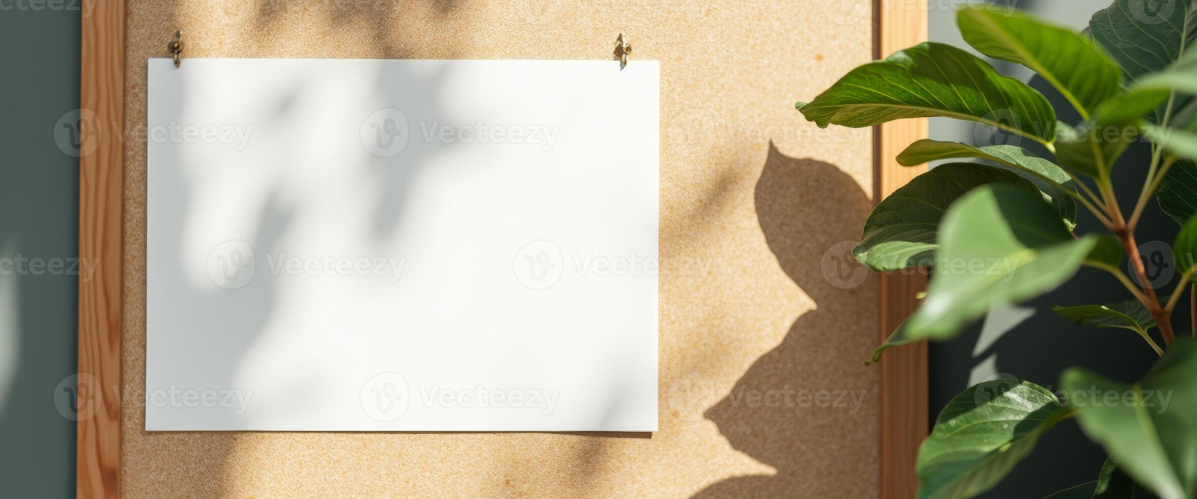 Blank Paper Mockup on Corkboard with Green Leaves photo