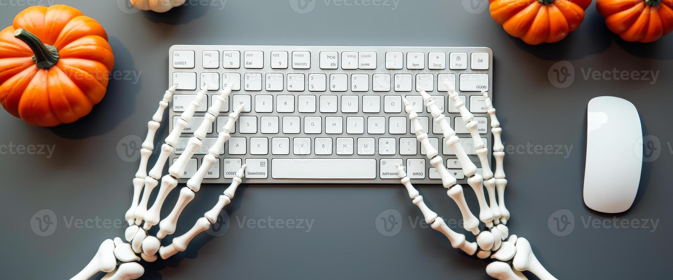 Skeleton Hands Typing on Keyboard with Pumpkins photo