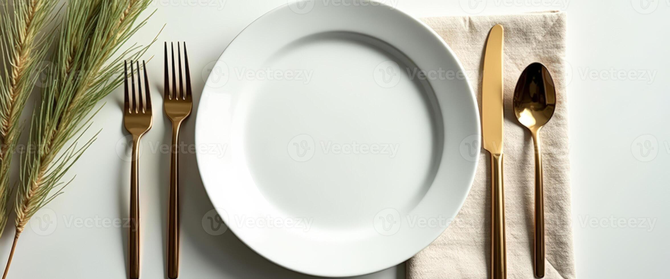 Elegant Table Setting with Gold Flatware and White Plate photo