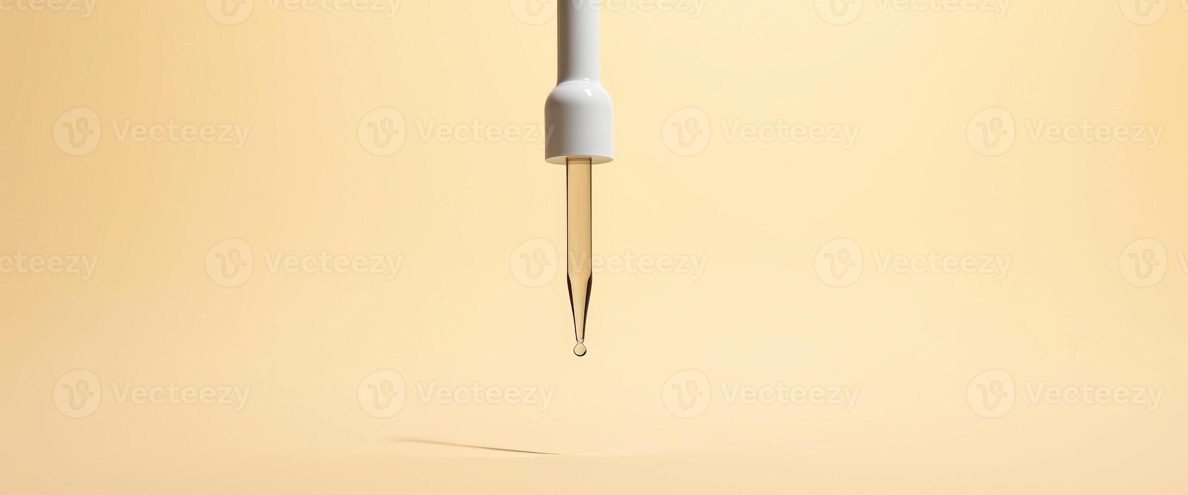 Dropper bottle with a single drop falling photo