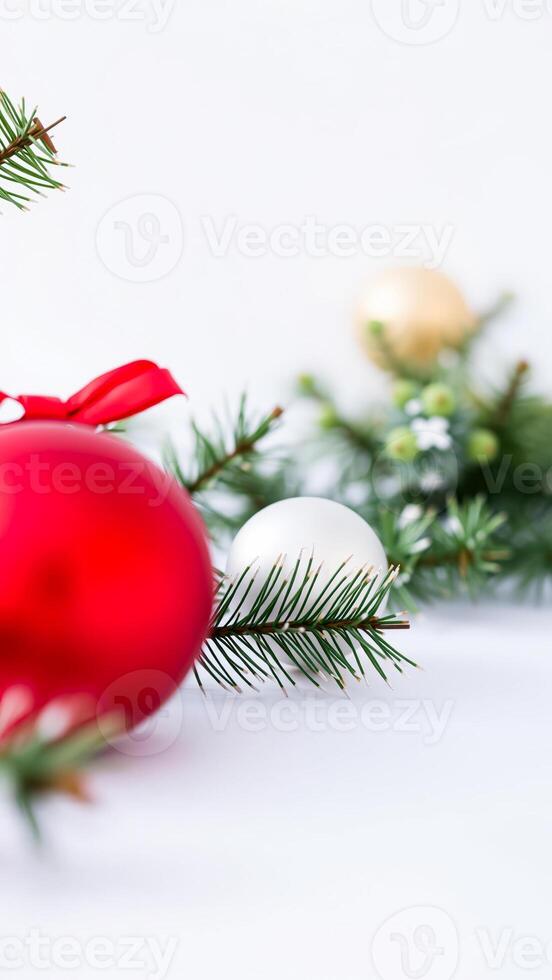 Red and White Christmas Baubles with Pine Branches on White Background photo