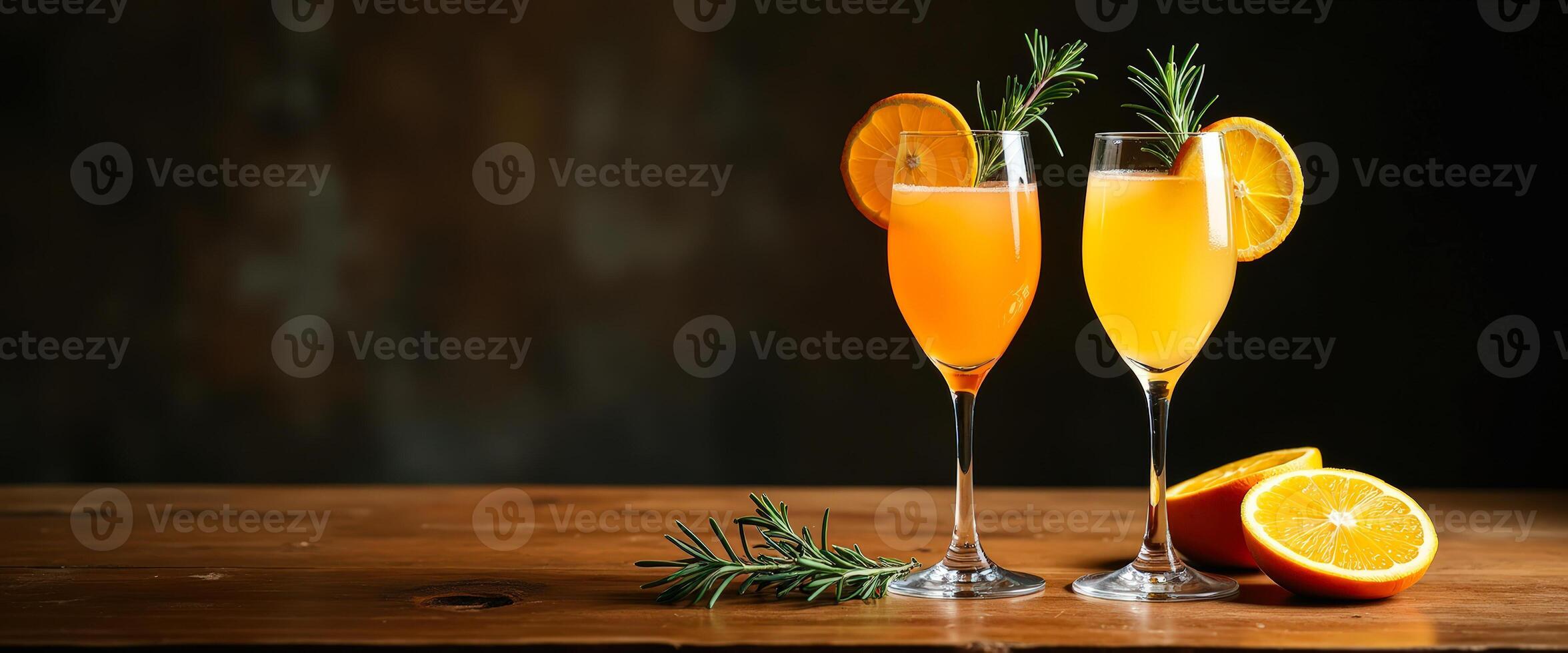 Two Orange Cocktails with Rosemary Garnish on Wooden Table photo
