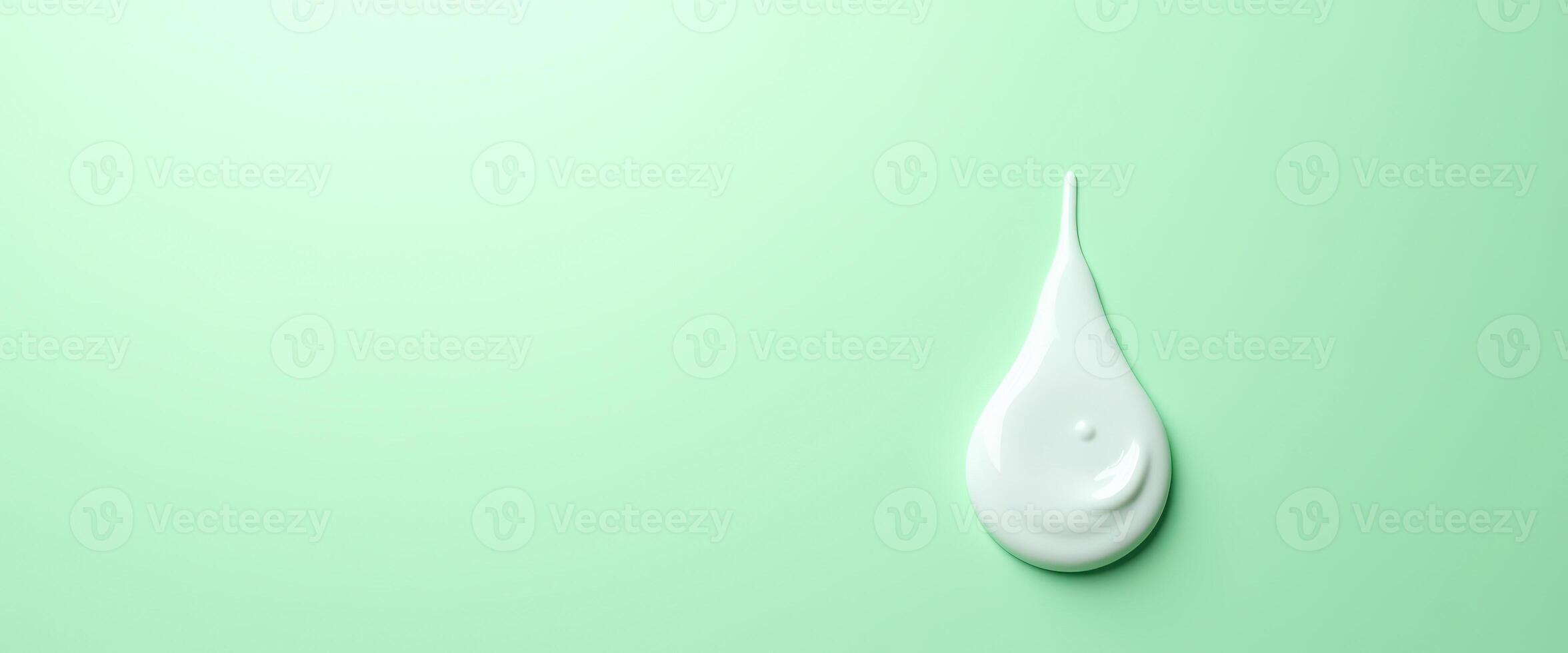 Drop of Cream on Green Background photo