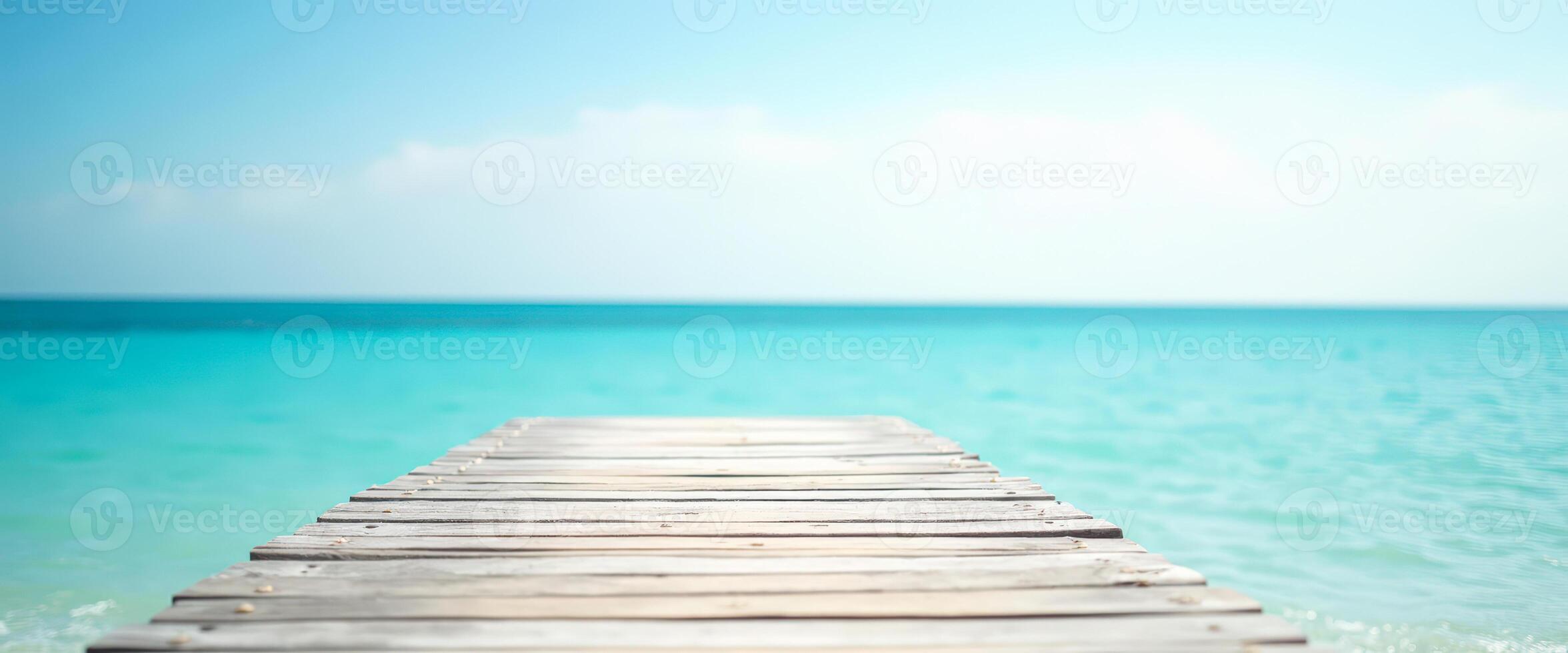 Wooden Pier Leading to Turquoise Sea photo