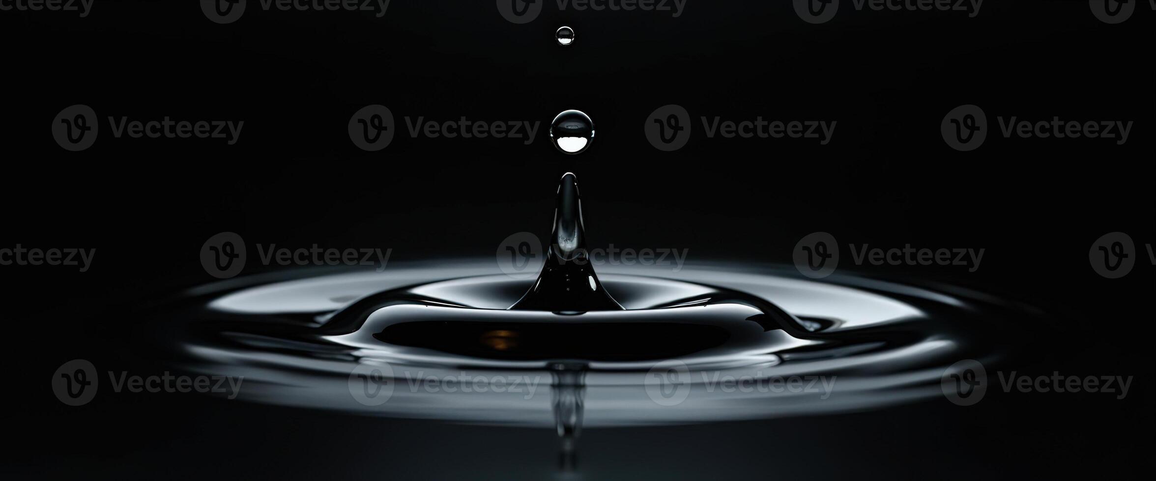 Water Droplet Splashing into Liquid photo