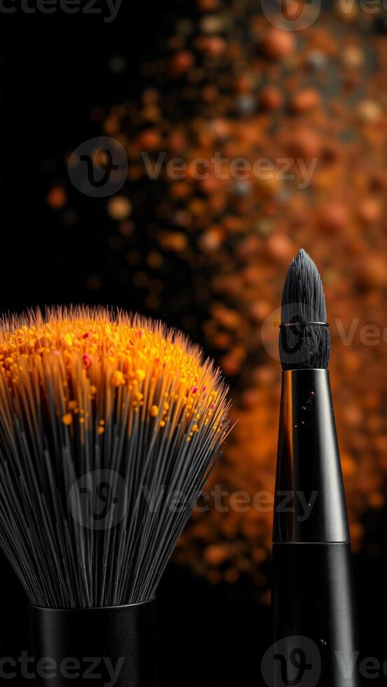 Makeup Brushes with Orange Glitter on Black Background photo