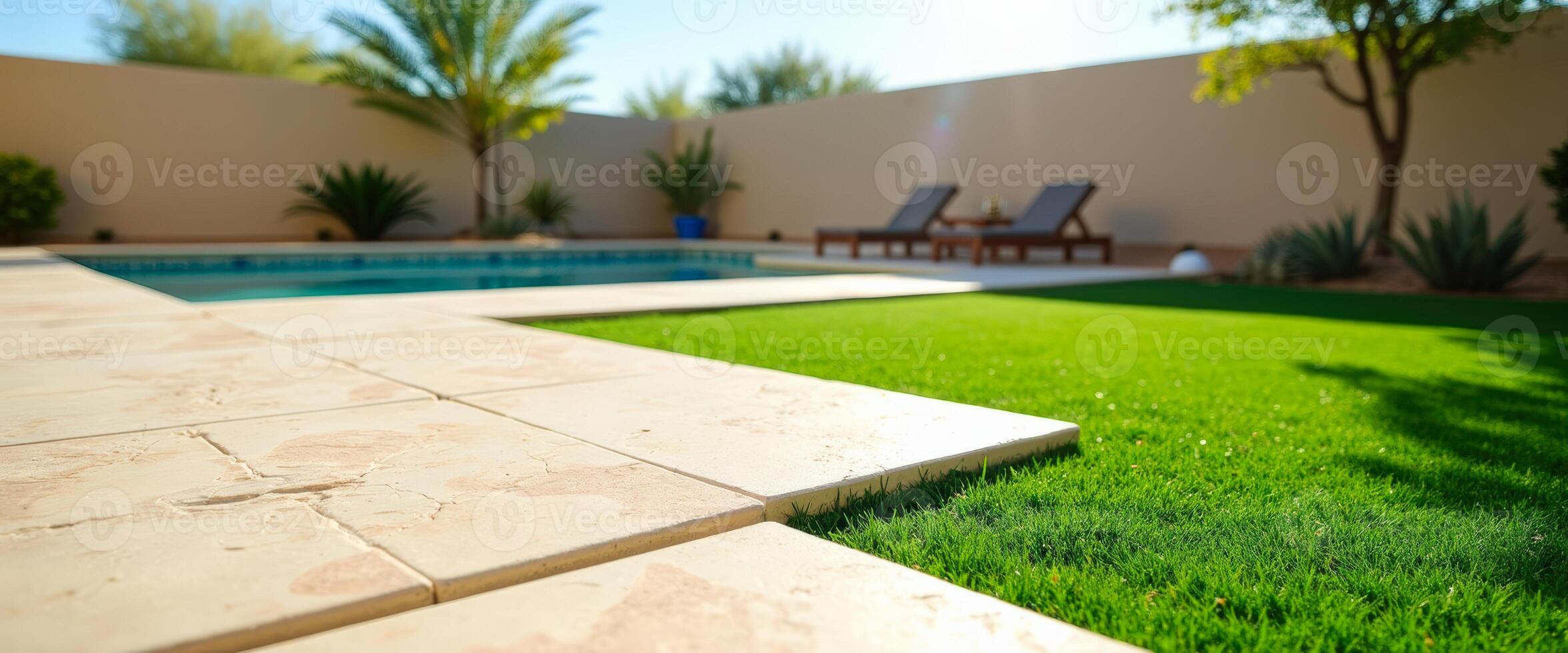 Lush Green Lawn Bordering a Sparkling Pool photo