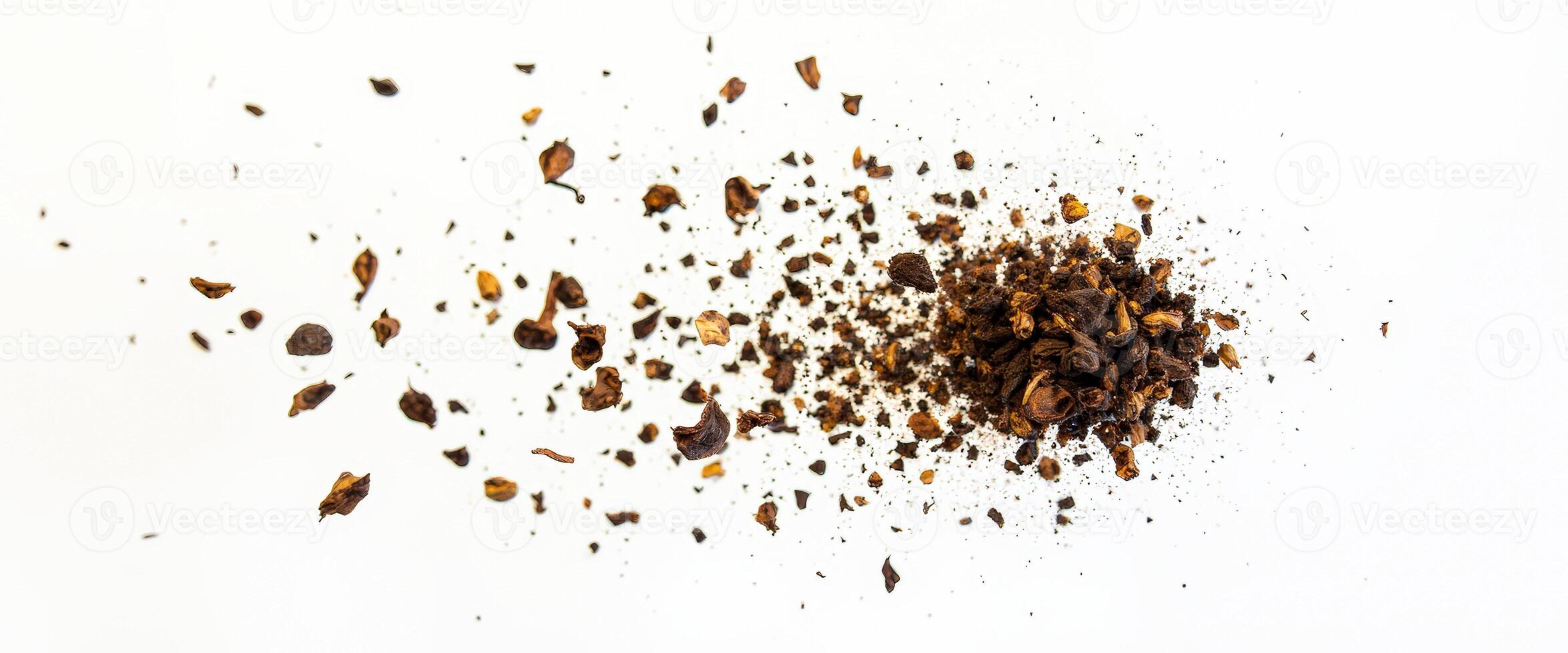 Crushed brown leaves on white background photo