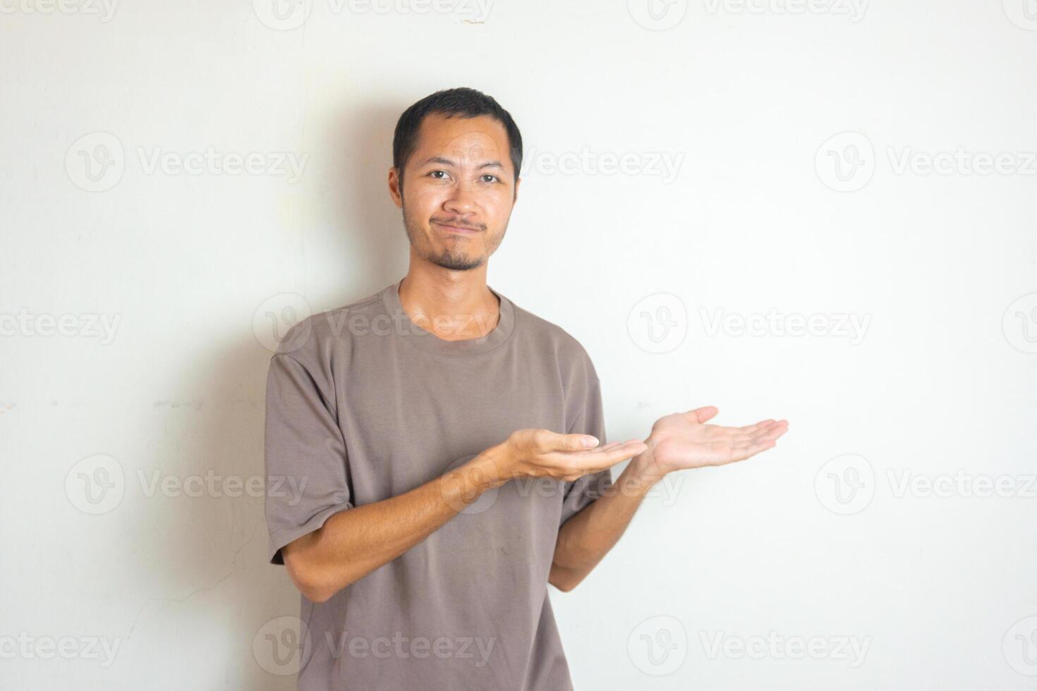 Young Adult Asian men pointing finger to the right with smiling face and exited expression with isolated white background photo