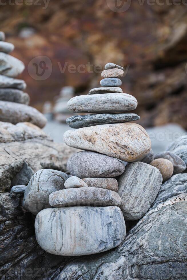 serene beach scene with smooth rocks stacked in a balanced formation. The tranquil atmosphere evokes a sense of zen, harmony, and peace, symbolizing balance and mindfulness in nature photo