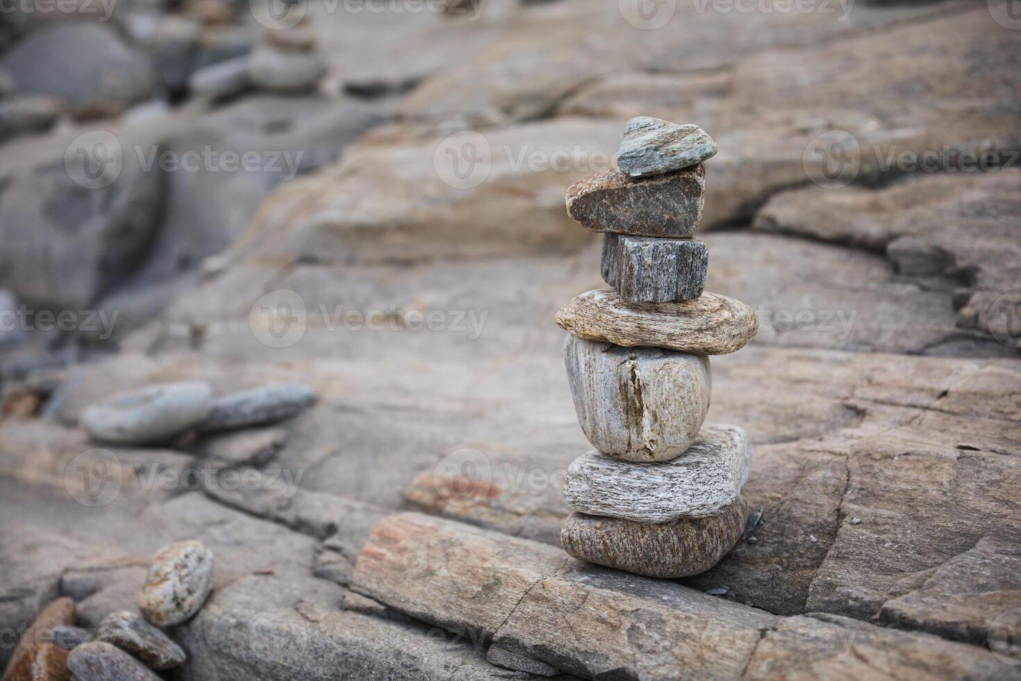 serene beach scene with smooth rocks stacked in a balanced formation. The tranquil atmosphere evokes a sense of zen, harmony, and peace, symbolizing balance and mindfulness in nature photo