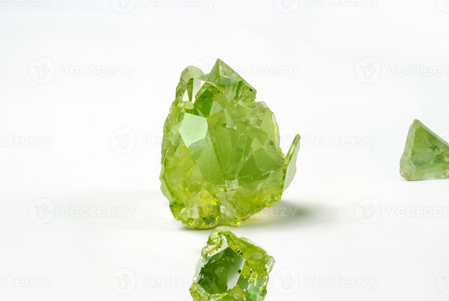 Close-up of Raw Green Peridot Crystal Isolated on White Background photo