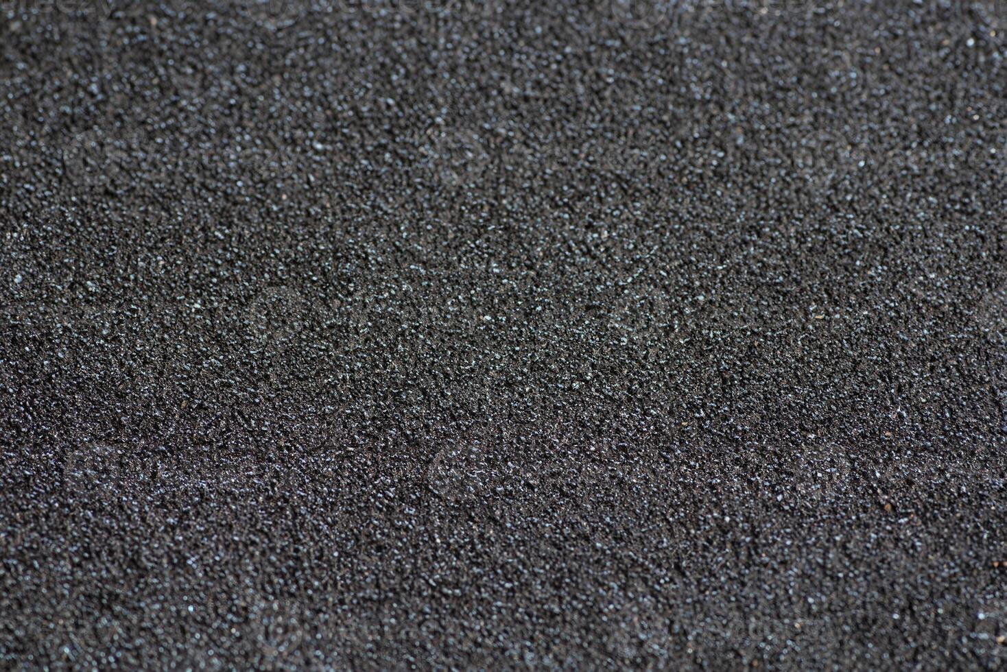 Detailed Close-Up of Coarse Sandpaper Surface photo
