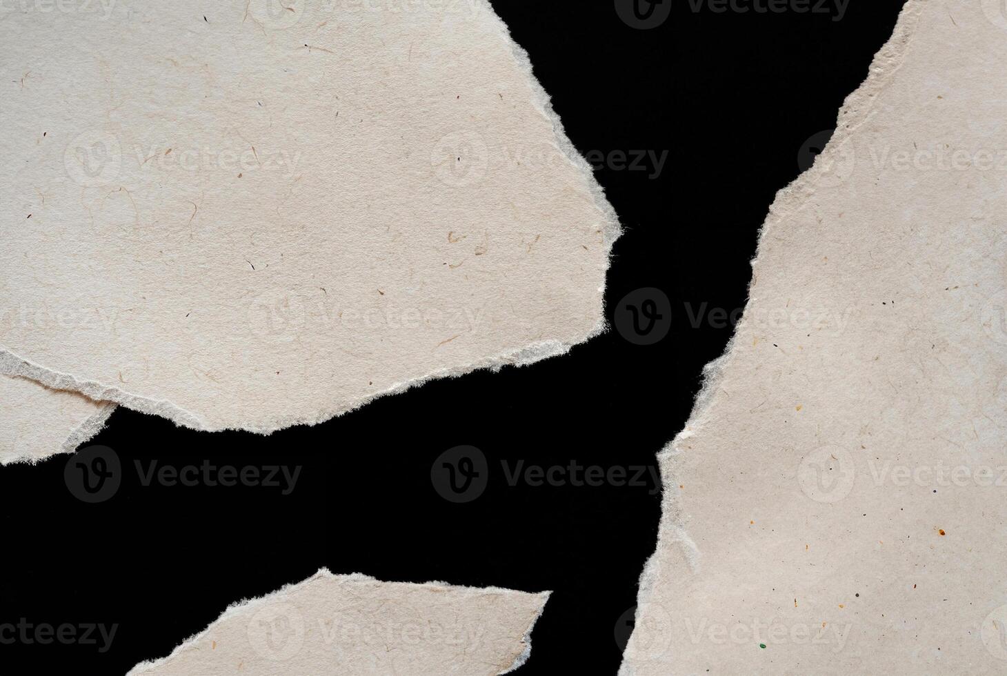 Abstract Torn Paper Texture with Jagged Edges on Black Background photo