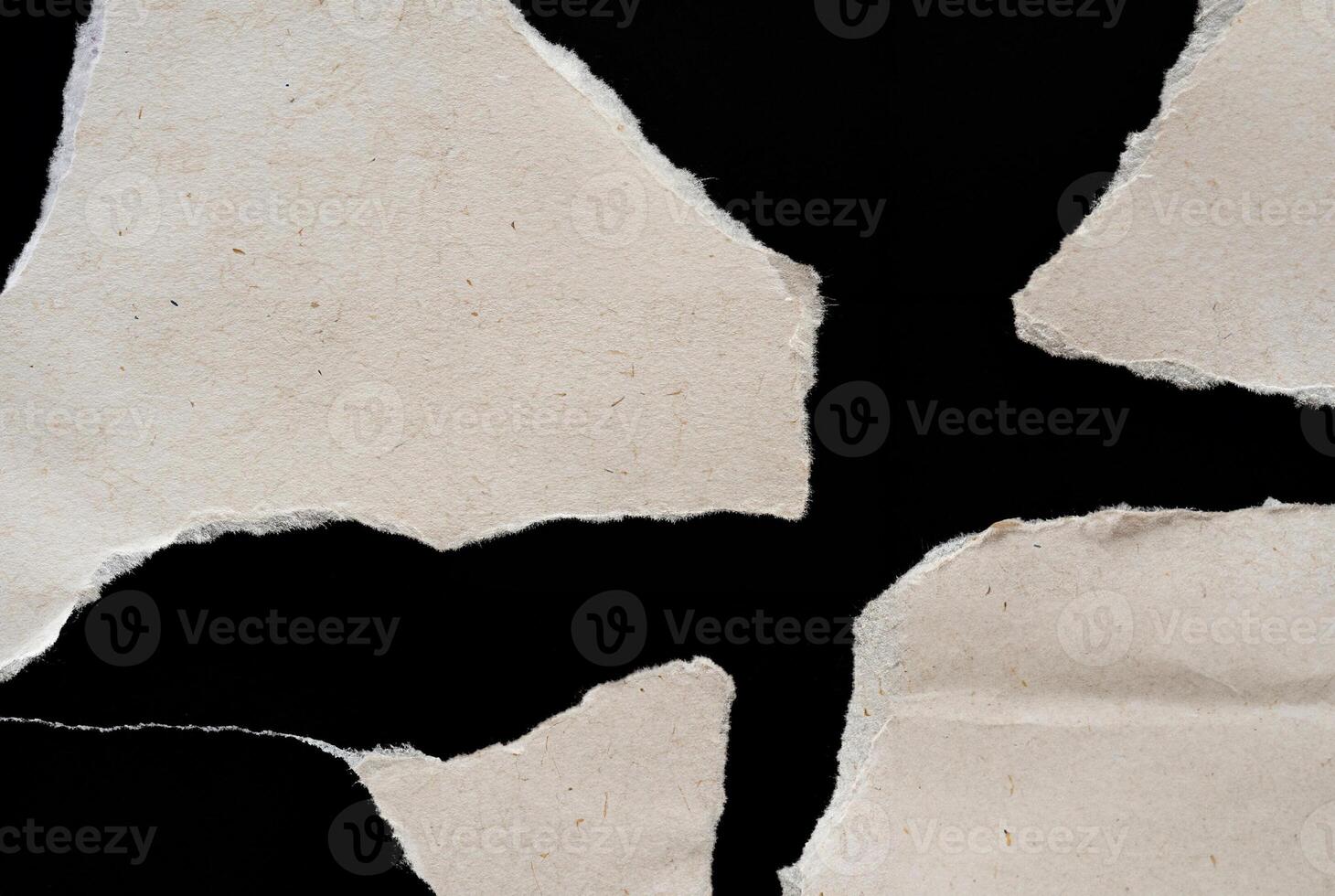 Abstract Torn Paper Texture with Jagged Edges on Black Background photo