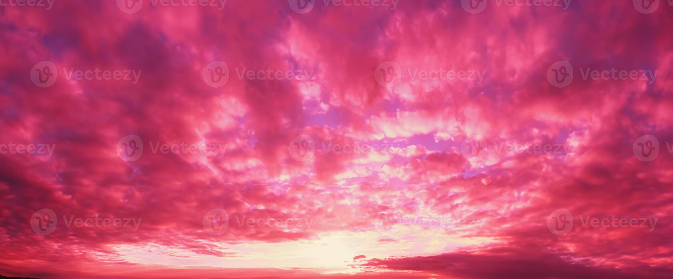 Panoramic View of a Vibrant Magenta Sunset Sky with Clouds photo