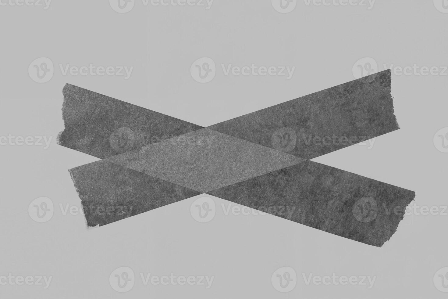 Black Adhesive Tape on Gray Background with Torn Edges photo