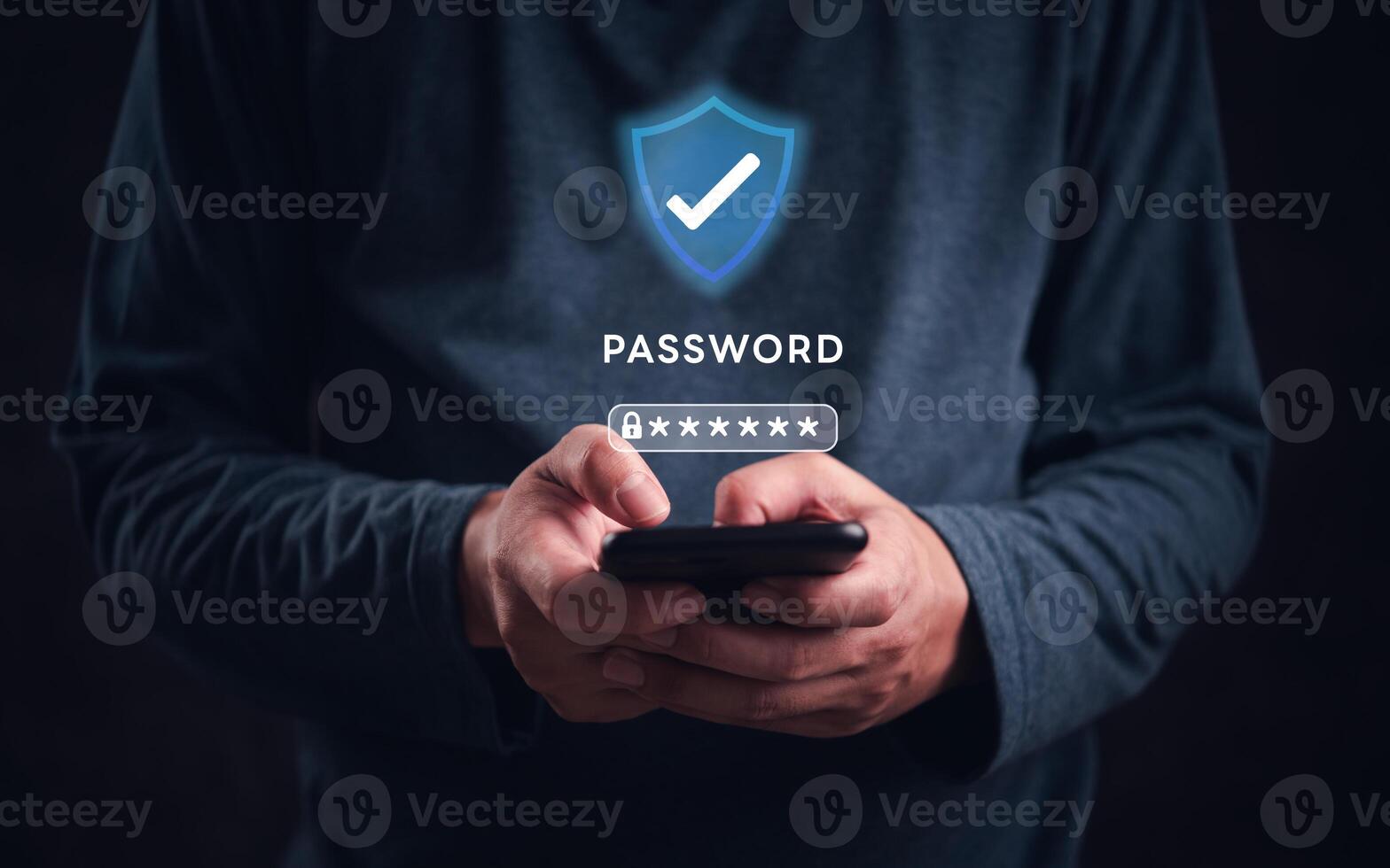 Man holding smartphone with password icon on dark background photo