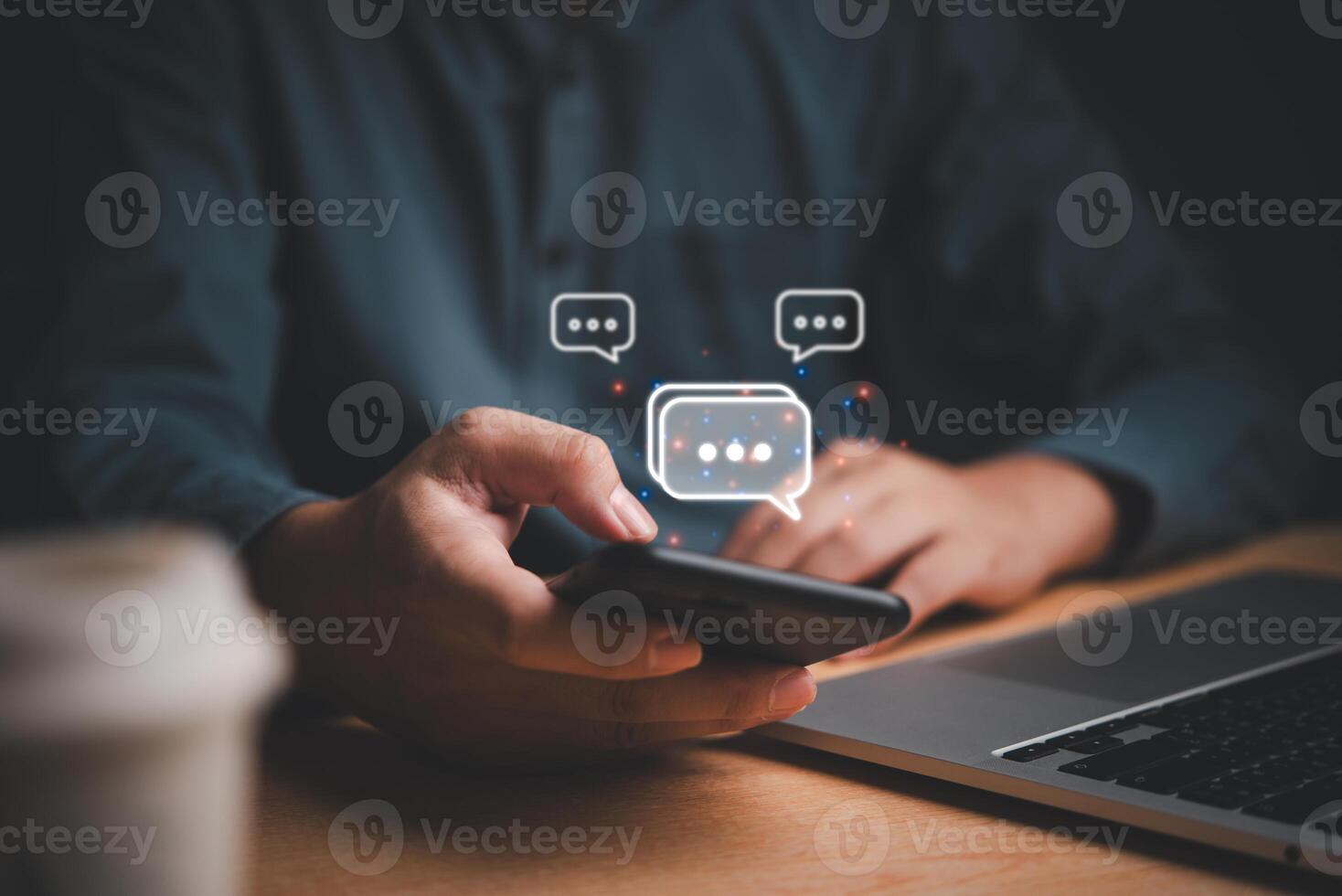 Business professional using smartphone displaying chat icons, concept of modern communication. photo