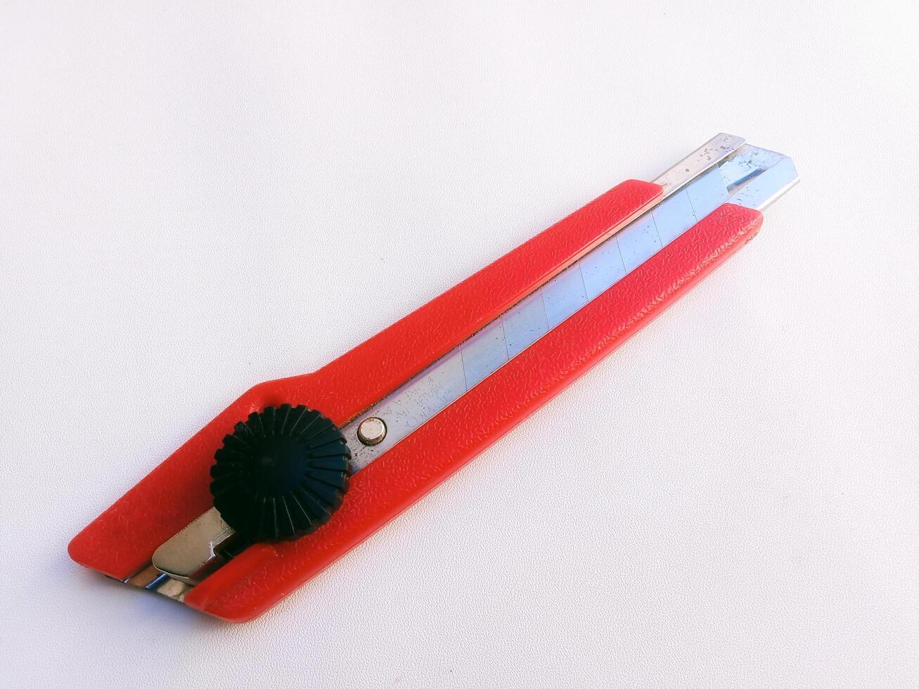 Close up horizontal shot of red cutting tool, white background,Taking photos from close range