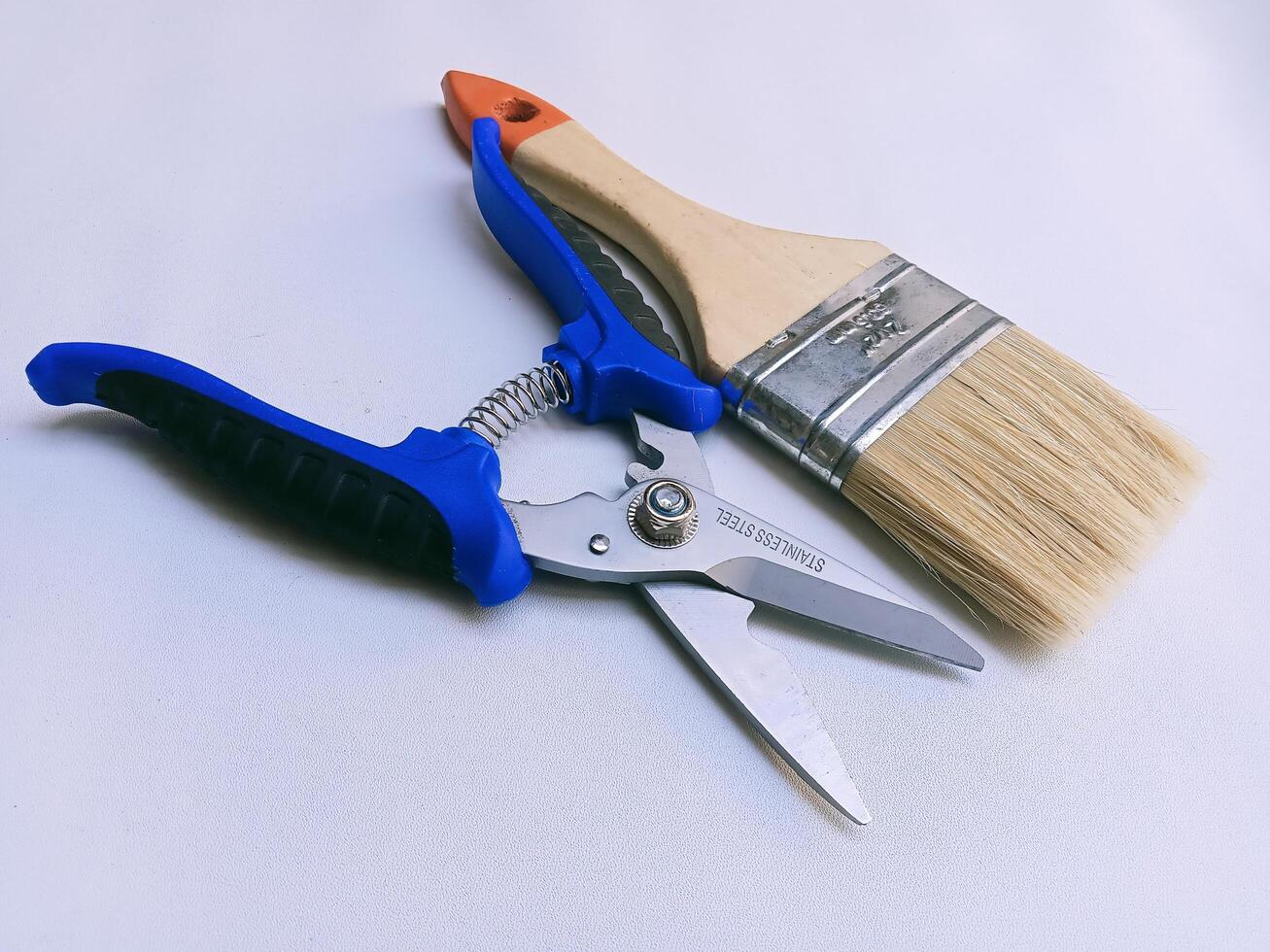 A pair of scissors and a paint brush photo
