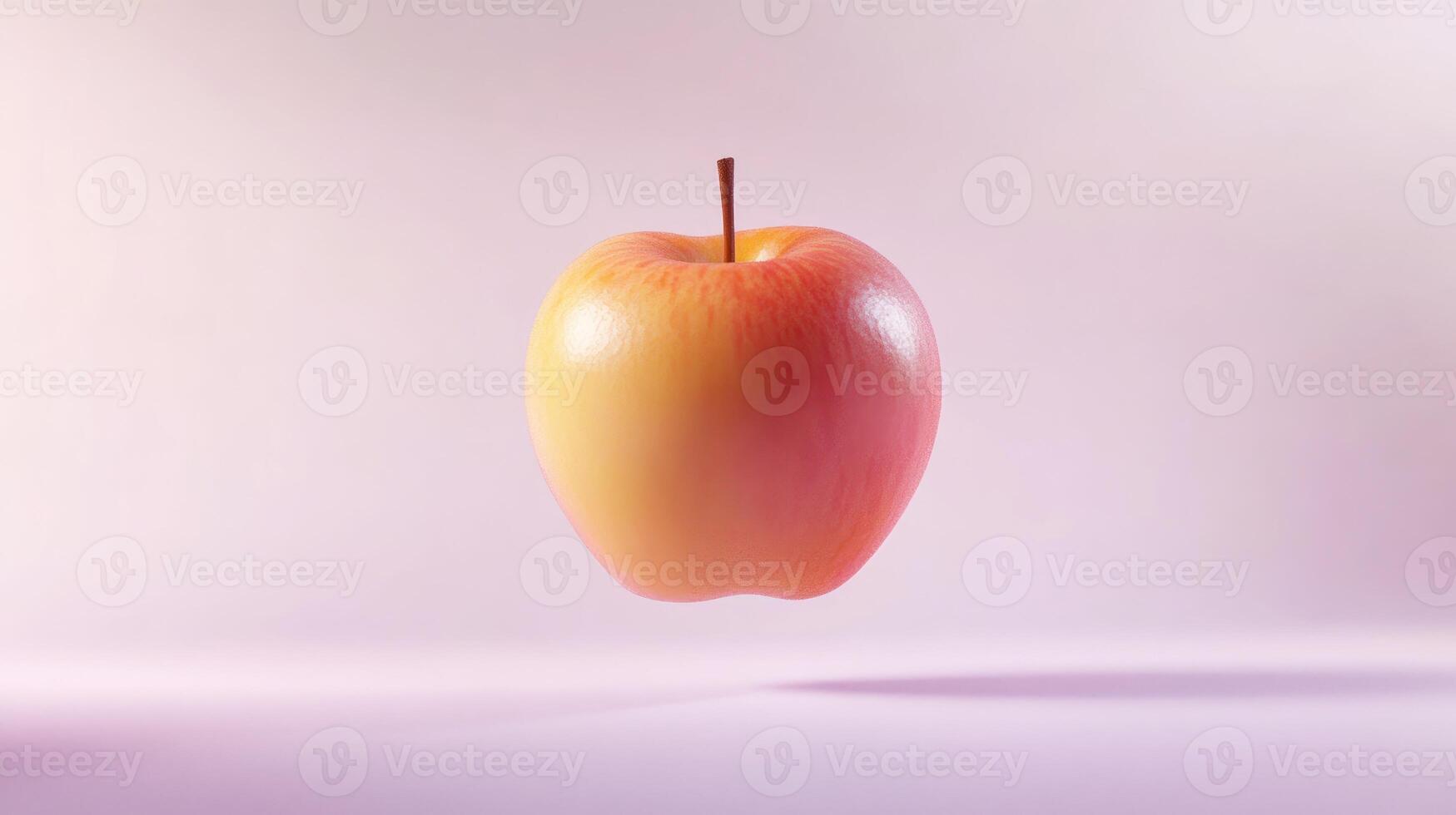 A Single Red and Yellow Apple Floating Against a Pink Background photo