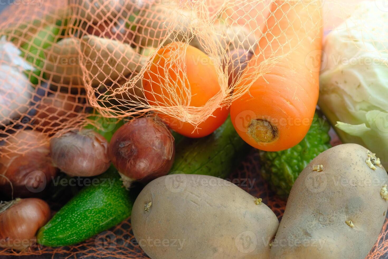 Fresh and Organic Vegetables in a Net Carrots, Potatoes, Zucchini, and Much More photo