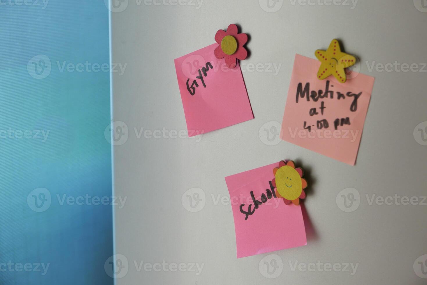 Vibrant and Colorful Sticky Notes Displayed on the Wall for Effective Reminder Purposes photo