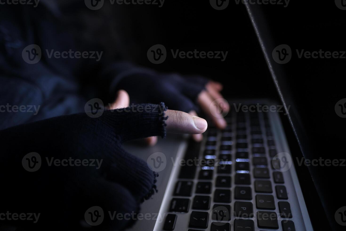 hacker hand stealing data from laptop top down photo