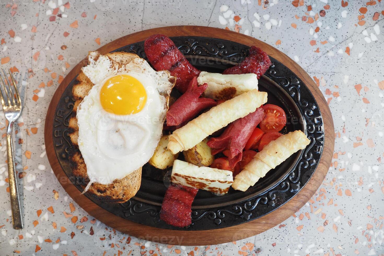 A Delicious Breakfast Platter that includes Egg, Bacon, Toast, and other delights photo