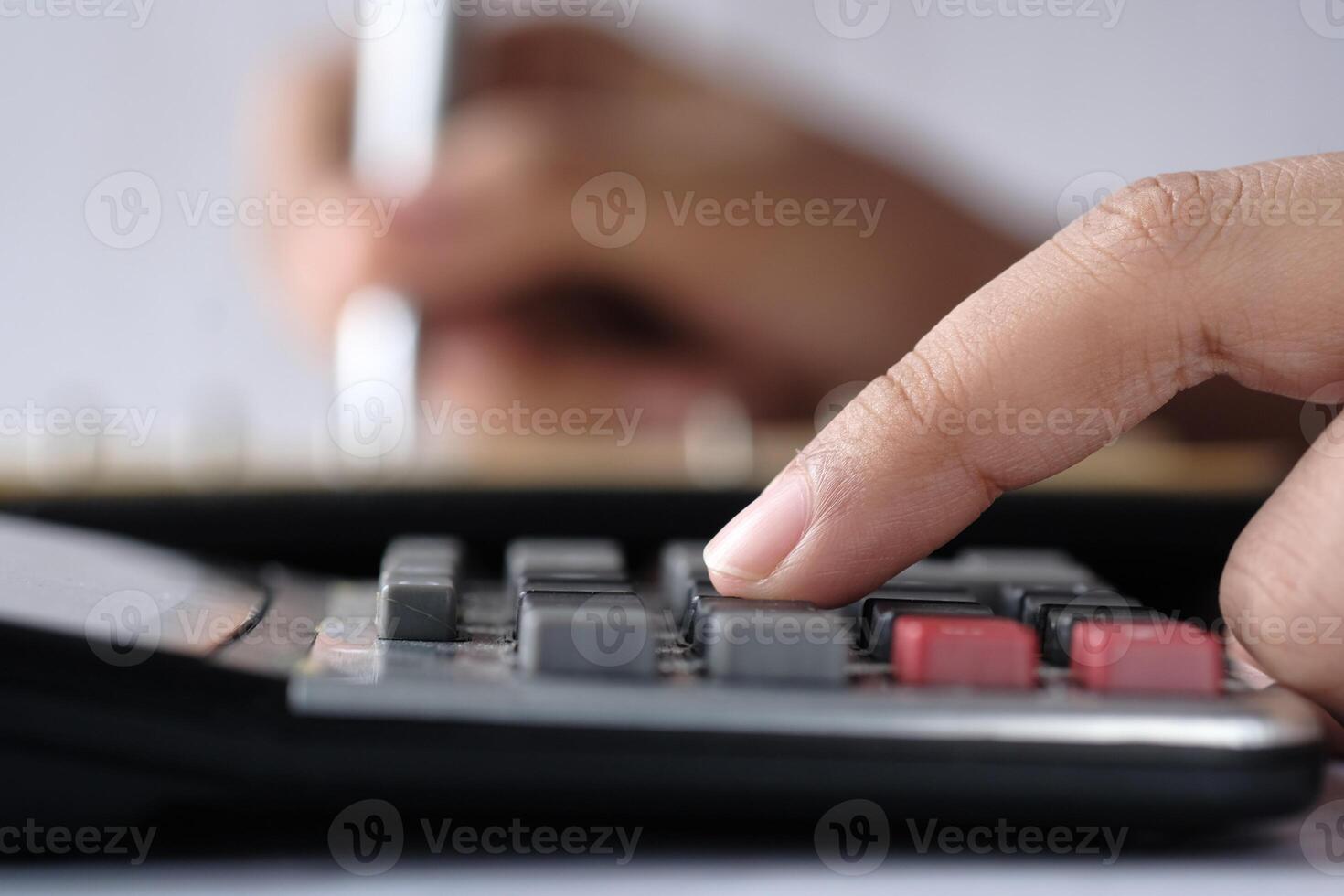 A Business Professional Engaged in Using a Calculator for Detailed Financial Analysis and Evaluation photo