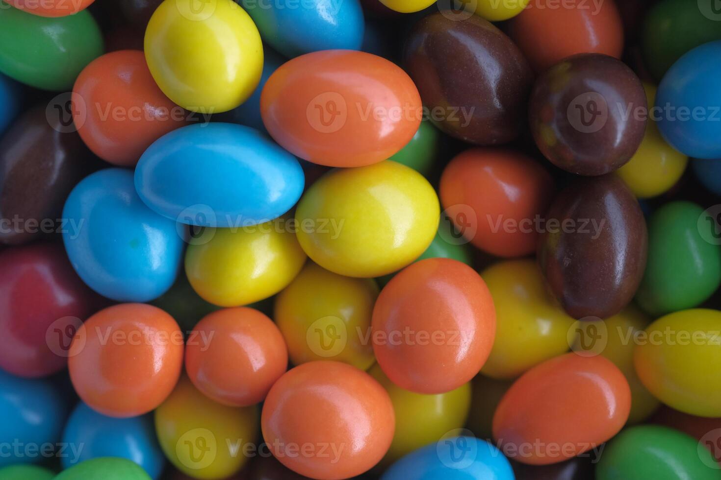 Colorful candies in a delightful shiny candy coating, showcasing various vibrant shades photo