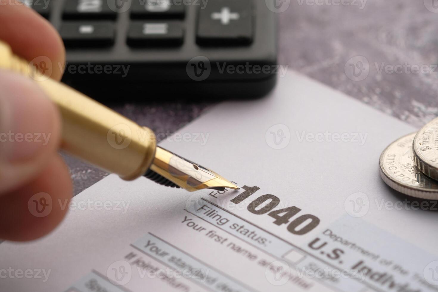 Tax Filing Using Form 1040, a Calculator, and Various Coins Placed on the Table Surface photo