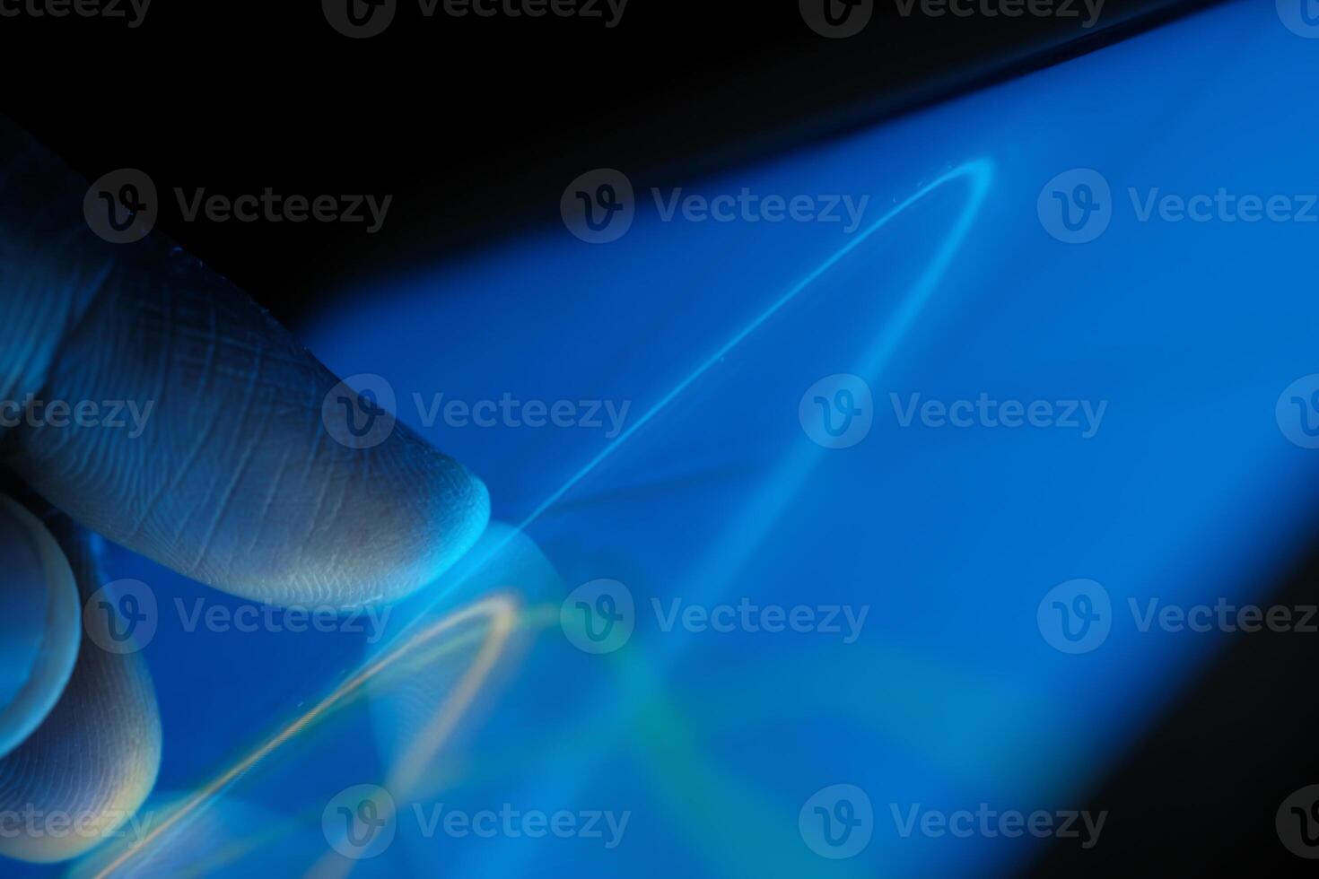 Experiencing Futuristic Touch Interaction with Bright and Vibrant Colorful Light Trails photo