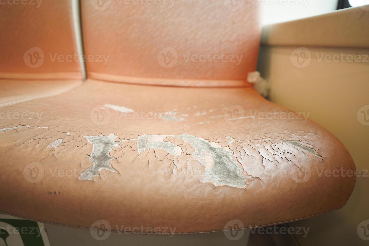 damage Leather with a cracked texture on a sofa . photo