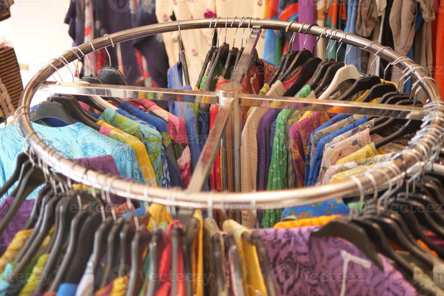 A Colorful Clothing Rack Display in a Retail Store Showcasing a Variety of Apparel and Accessories photo