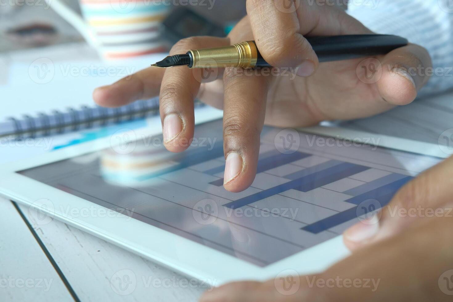 Performing a comprehensive Business Analysis using a Digital Tablet, Pen, and Notepad photo
