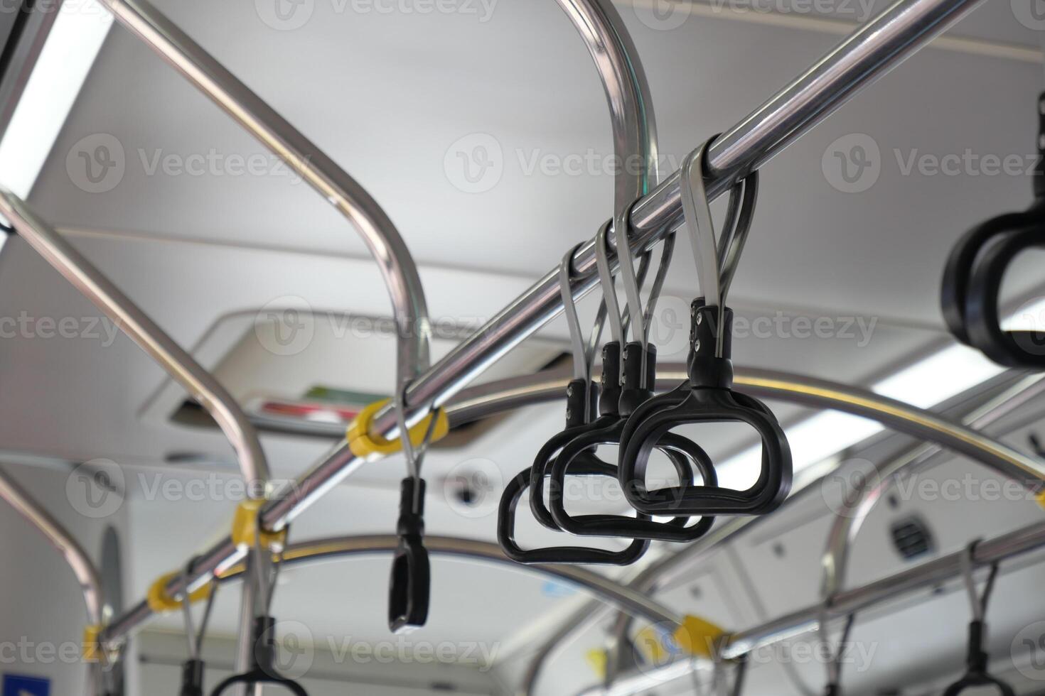 An Interior View Highlighting the Handrails and Grab Bars of a Public Bus for Safety photo
