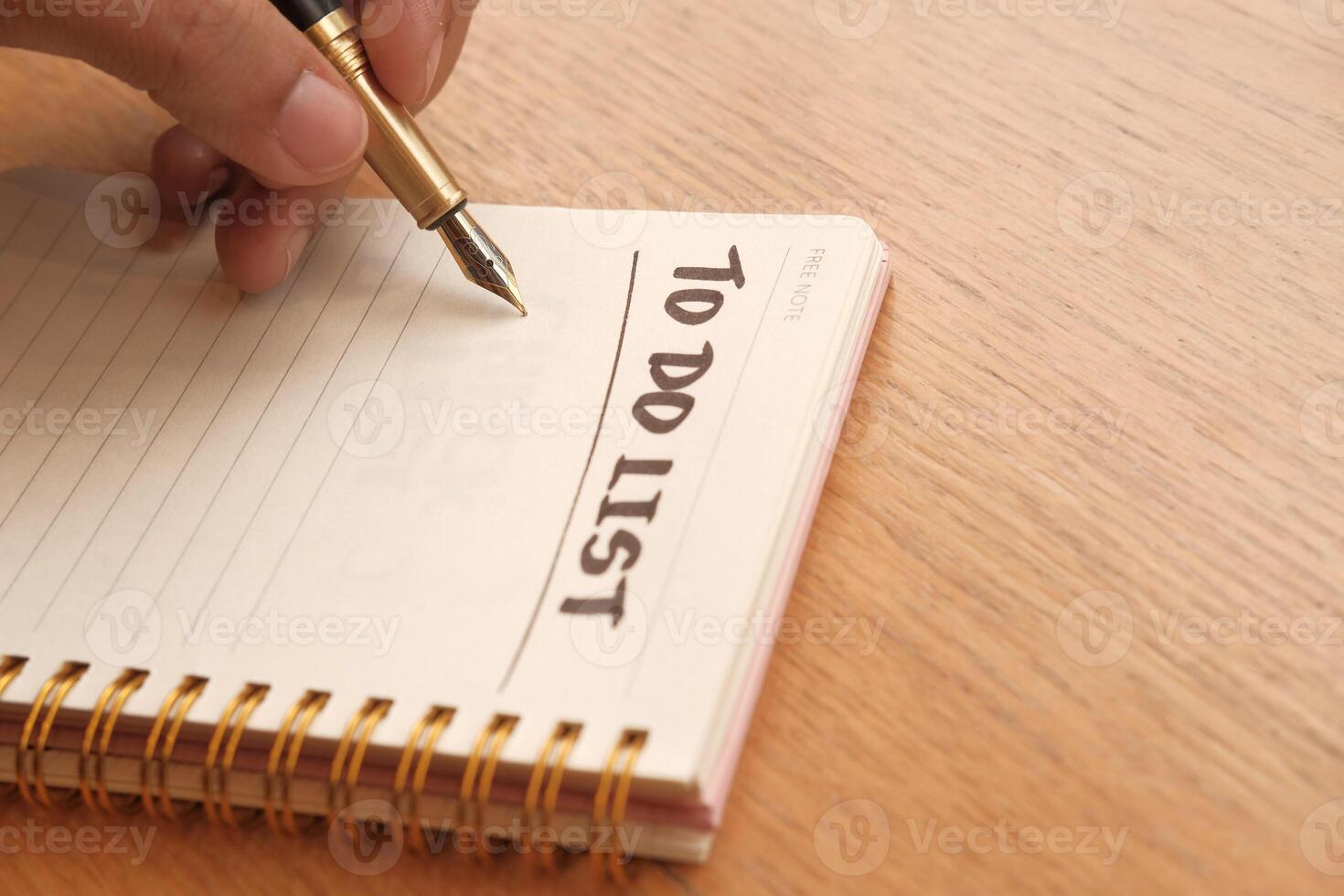 Creating a Hand Written To Do List within a Notebook Using a Pen for Tasks and Ideas photo
